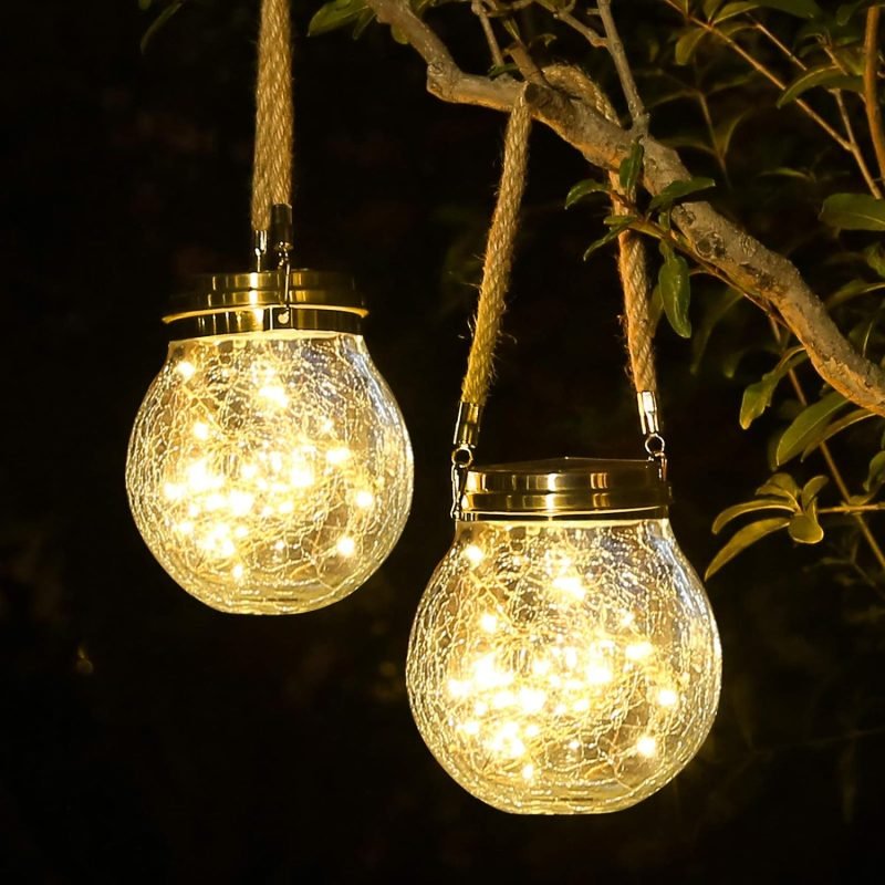 Large glass ball with cracks, solar energy, twine hand, warm white, hanging from the branch